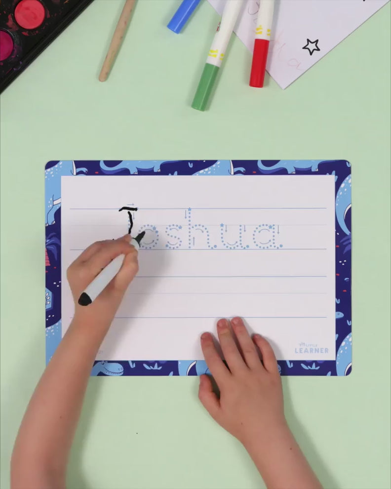 Child tracing their name on a personalised My Little Learner writing mat